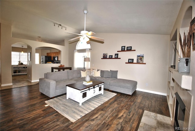 living room with plenty of natural light, dark hardwood / wood-style floors, and ceiling fan