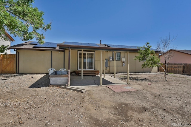 8381 Vine St, Denver, CO 80229 - rear view of property featuring roof mounted solar panels, a fenced backyard, a patio area, and entry steps