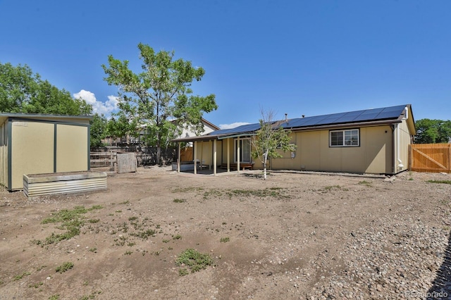 8381 Vine St, Denver, CO 80229 - back of house featuring roof mounted solar panels, a fenced backyard, and a patio