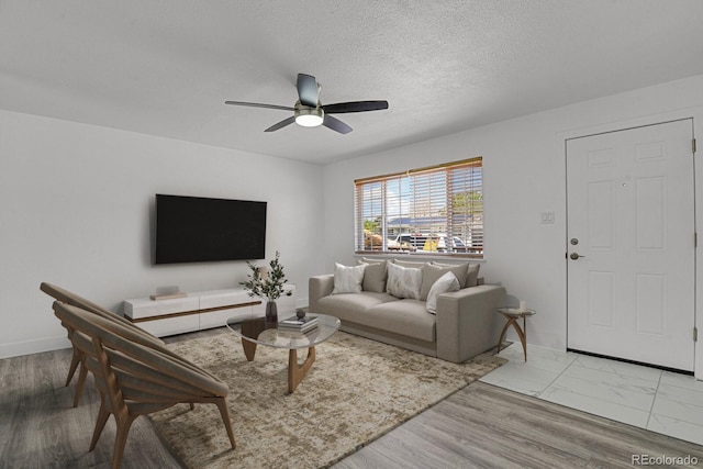 8381 Vine St, Denver, CO 80229 - living room featuring ceiling fan and a textured ceiling