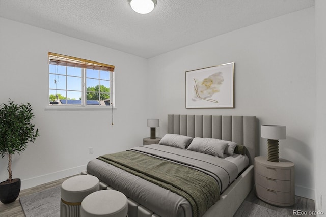 8381 Vine St, Denver, CO 80229 - bedroom with wood finished floors and a textured ceiling