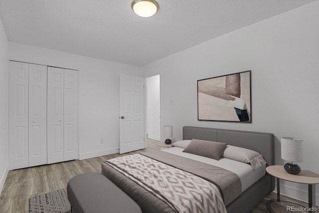8381 Vine St, Denver, CO 80229 - bedroom with wood finished floors, a textured ceiling, and a closet