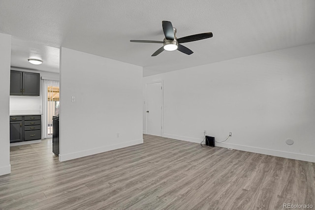 8381 Vine St, Denver, CO 80229 - unfurnished living room with ceiling fan, light wood-style flooring, and a textured ceiling