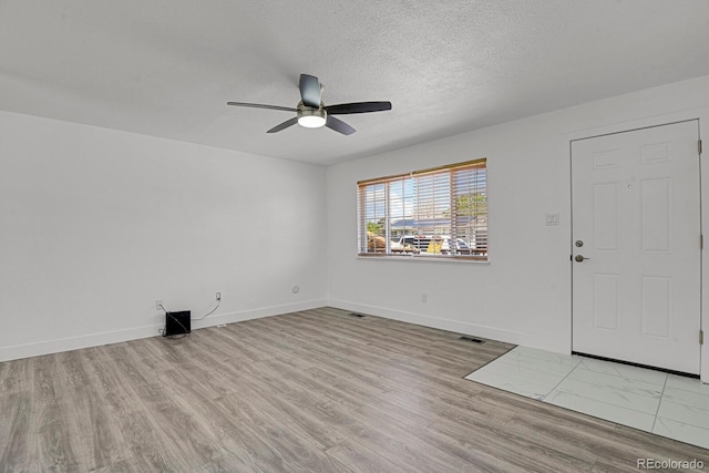 8381 Vine St, Denver, CO 80229 - entryway featuring ceiling fan, wood finished floors, and a textured ceiling