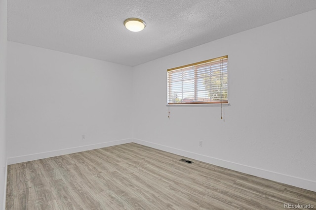 8381 Vine St, Denver, CO 80229 - empty room with light wood finished floors and a textured ceiling