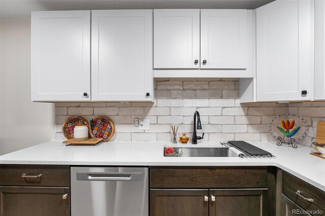 495 S Dayton St Unit 1C, Denver, CO 80247 - kitchen with dishwasher, light countertops, backsplash, and white cabinets