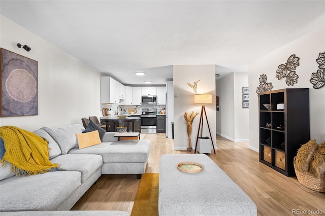 495 S Dayton St Unit 1C, Denver, CO 80247 - living area with baseboards, light wood finished floors, and recessed lighting
