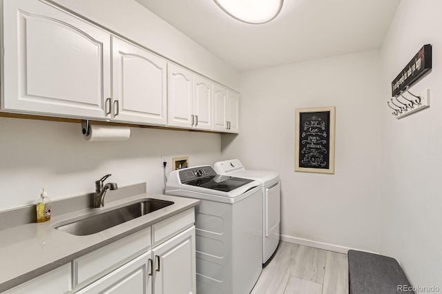 8862 Chestnut Hill Ln, Highlands Ranch, CO 80130 - washroom with cabinet space, separate washer and dryer, light wood finished floors, and baseboards