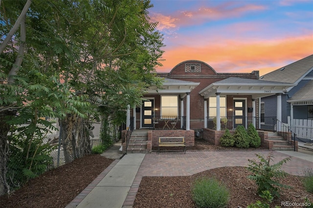 3444 Lawrence St, Denver, CO 80205 - view of front of house with a porch and brick siding