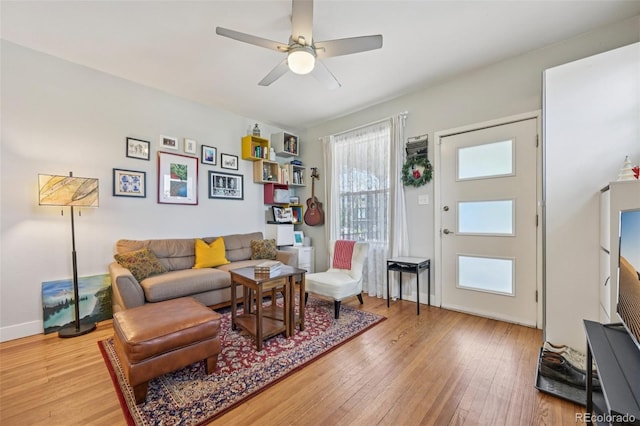 3444 Lawrence St, Denver, CO 80205 - living area with light wood-style flooring, ceiling fan, and baseboards