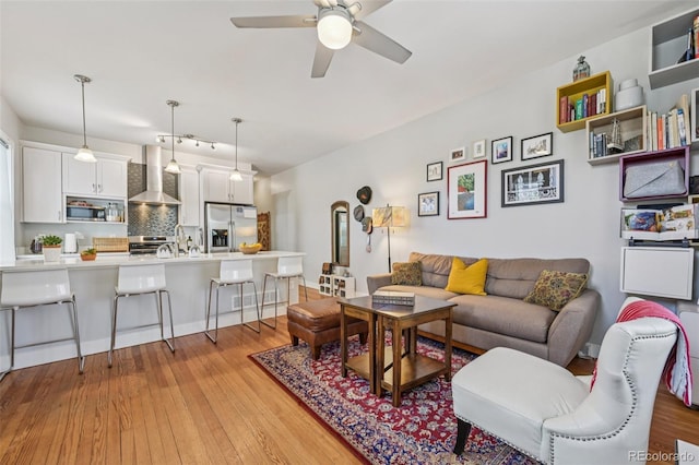 3444 Lawrence St, Denver, CO 80205 - living area featuring ceiling fan and light wood finished floors