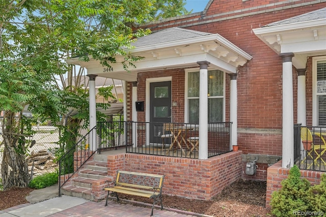 3444 Lawrence St, Denver, CO 80205 - view of exterior entry featuring a porch and brick siding