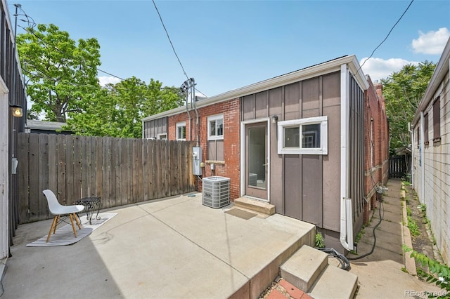 3444 Lawrence St, Denver, CO 80205 - back of house featuring board and batten siding, a fenced backyard, a patio area, and entry steps