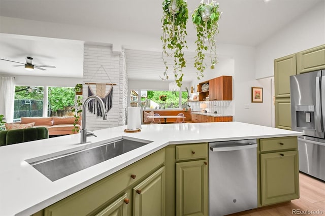 5200 W Rowland Ave, Littleton, CO 80128 - kitchen featuring green cabinetry, appliances with stainless steel finishes, a sink, a ceiling fan, and healthy amount of natural light