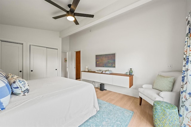 5200 W Rowland Ave, Littleton, CO 80128 - bedroom with lofted ceiling, multiple closets, wood finished floors, and a ceiling fan