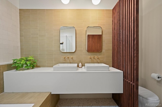 5200 W Rowland Ave, Littleton, CO 80128 - full bathroom with tile walls, double vanity, and toilet