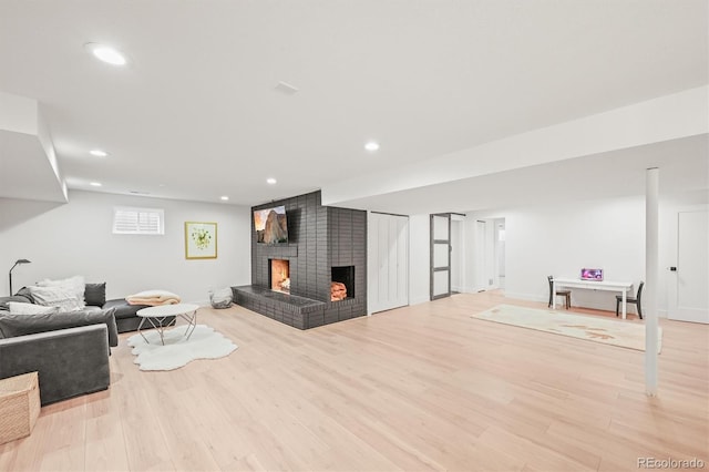 5200 W Rowland Ave, Littleton, CO 80128 - living area with a brick fireplace, wood finished floors, recessed lighting, and baseboards