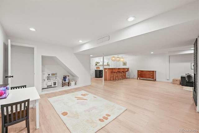5200 W Rowland Ave, Littleton, CO 80128 - living area featuring light wood-style floors, bar area, and recessed lighting