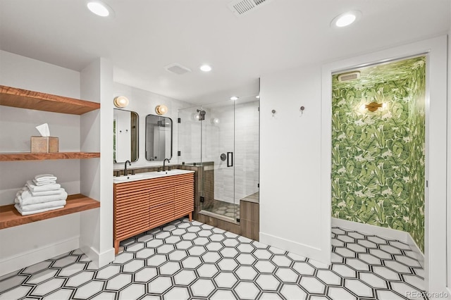 5200 W Rowland Ave, Littleton, CO 80128 - full bath featuring baseboards, double vanity, a stall shower, recessed lighting, and tile patterned floors