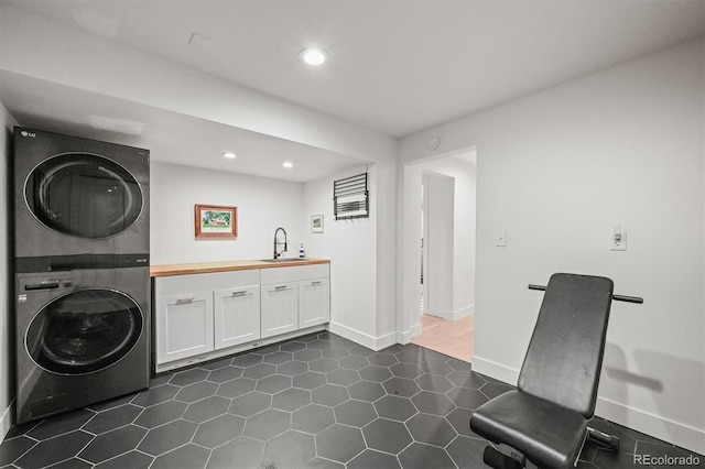 5200 W Rowland Ave, Littleton, CO 80128 - laundry area with stacked washer / dryer, wet bar, cabinet space, recessed lighting, and baseboards