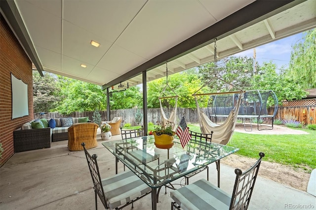 5200 W Rowland Ave, Littleton, CO 80128 - view of patio featuring a trampoline, outdoor lounge area, and outdoor dining space