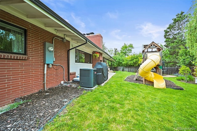 5200 W Rowland Ave, Littleton, CO 80128 - view of yard featuring a playground and central AC