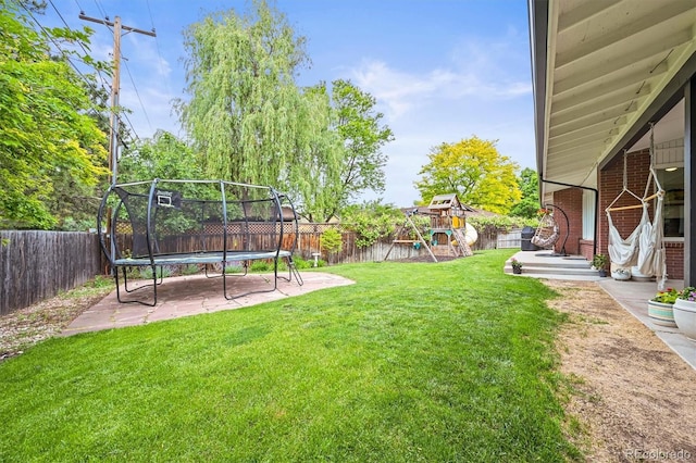 5200 W Rowland Ave, Littleton, CO 80128 - view of yard featuring a trampoline, a playground, and a patio