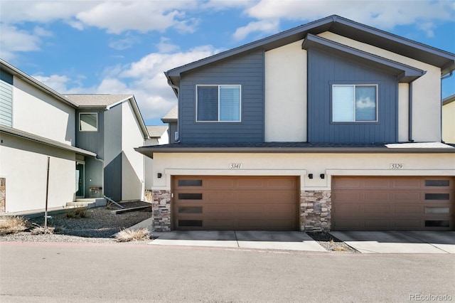 view of front of house featuring stone siding and an attached garage