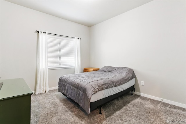 carpeted bedroom featuring baseboards