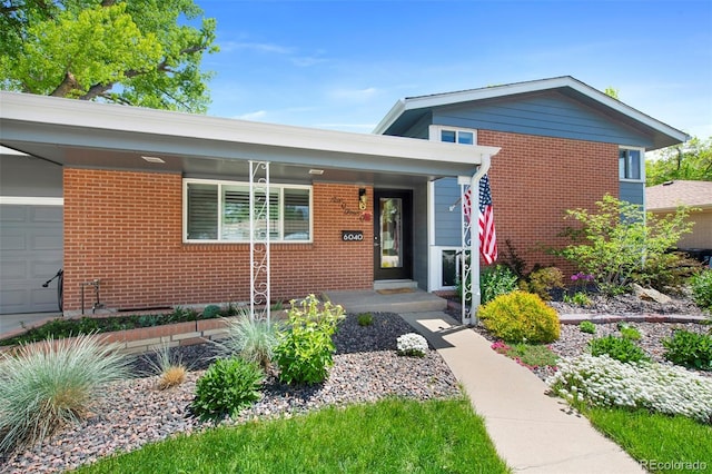 6040 Taft Ct, Arvada, CO 80004 - view of front facade with brick siding and a garage