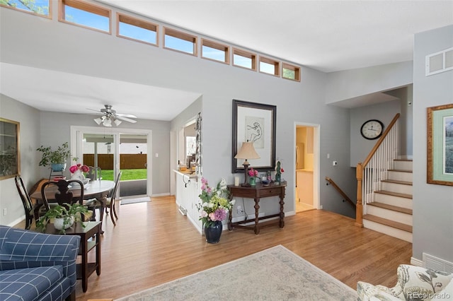6040 Taft Ct, Arvada, CO 80004 - living room featuring light wood-style floors, stairway, a ceiling fan, and baseboards