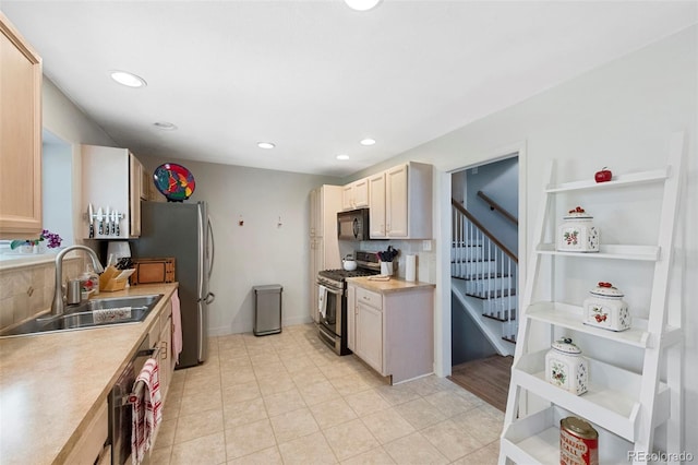 6040 Taft Ct, Arvada, CO 80004 - kitchen with appliances with stainless steel finishes, a sink, light countertops, light tile patterned floors, and recessed lighting