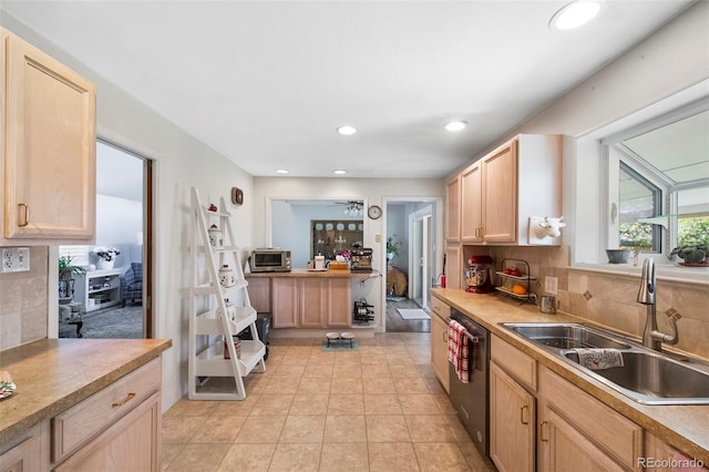 6040 Taft Ct, Arvada, CO 80004 - kitchen featuring dishwasher, a sink, light brown cabinets, decorative backsplash, and light countertops