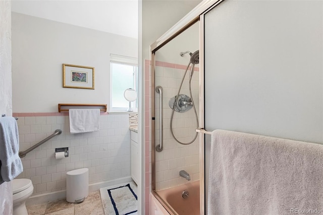 6040 Taft Ct, Arvada, CO 80004 - full bathroom with tile walls, tile patterned flooring, toilet, enclosed tub / shower combo, and a wainscoted wall