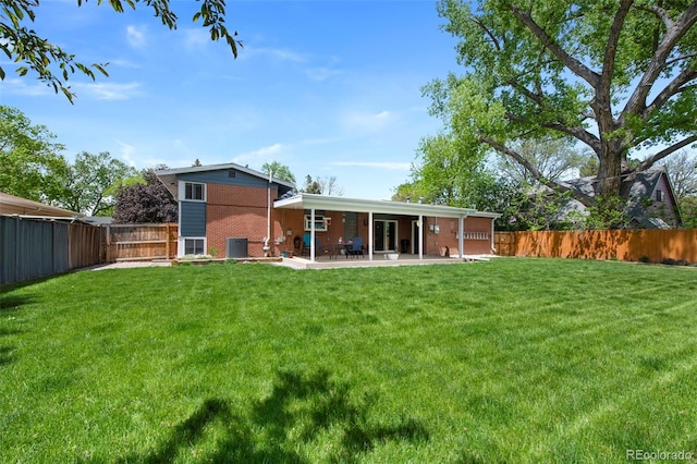 6040 Taft Ct, Arvada, CO 80004 - rear view of house with a patio and brick siding