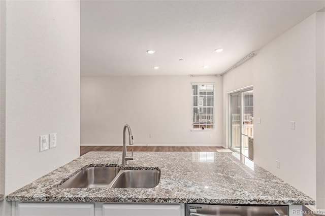 14065 Harrison St, Thornton, CO 80602 - kitchen with wood finished floors, light stone countertops, dishwasher, and recessed lighting