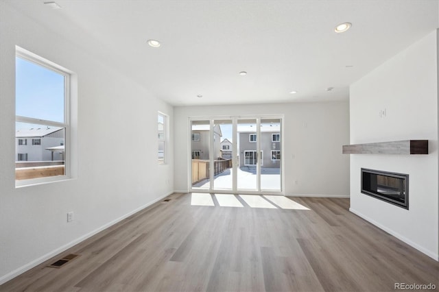 unfurnished living room with light hardwood / wood-style floors