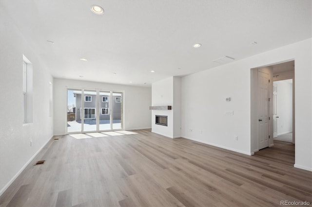 unfurnished living room featuring light wood-type flooring