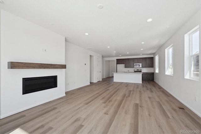 unfurnished living room featuring light wood-type flooring