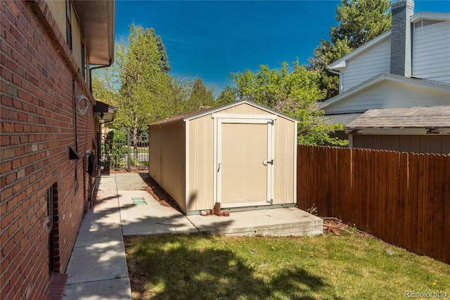 view of shed featuring fence
