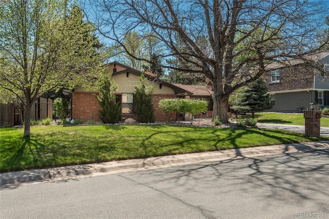 view of front of property with brick siding and stucco siding