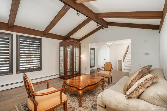 living area with wood finished floors, stairway, a chandelier, and a baseboard heating unit