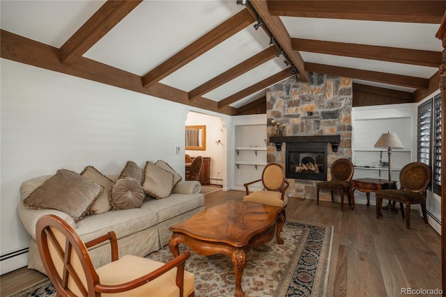 living area featuring wood finished floors, a stone fireplace, and a baseboard heating unit