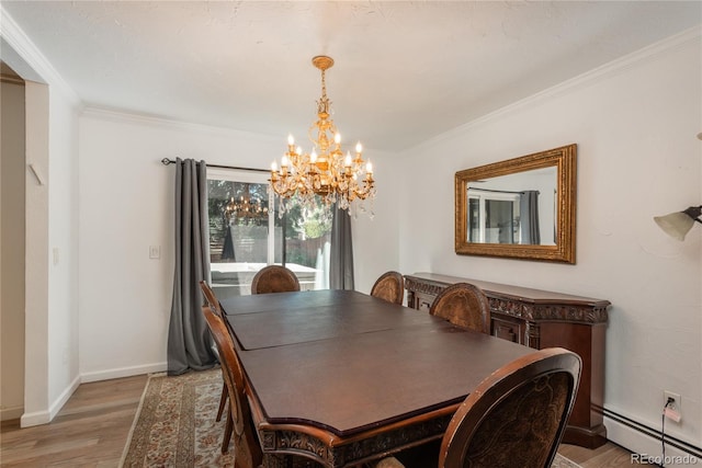 dining space with a baseboard radiator, a chandelier, light wood-type flooring, ornamental molding, and baseboards
