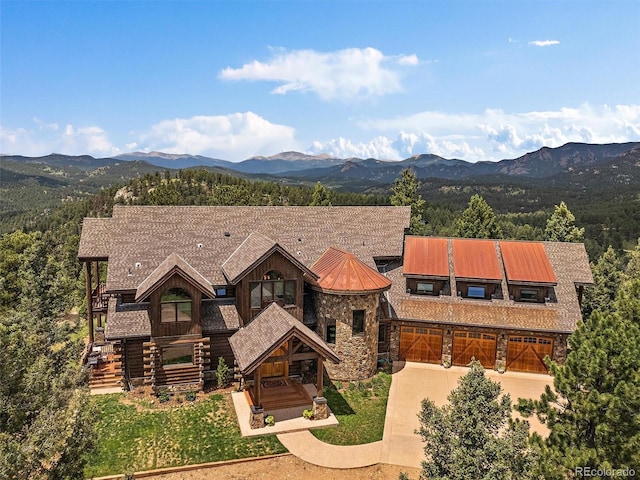 29548 Sunset Trl, Pine, CO 80470 - view of front of home with concrete driveway, a mountain view, and stone siding