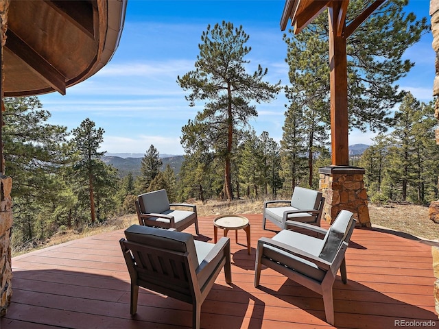 29548 Sunset Trl, Pine, CO 80470 - deck with a wooded view and a mountain view