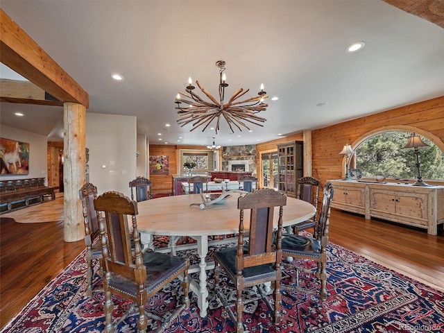 29548 Sunset Trl, Pine, CO 80470 - dining area with wooden walls, wood finished floors, an inviting chandelier, and recessed lighting