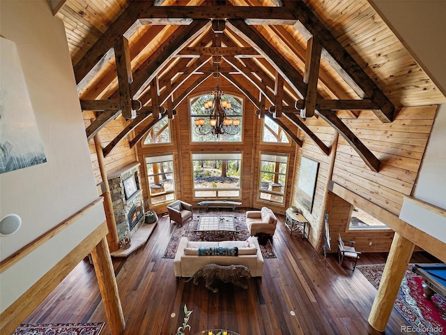 29548 Sunset Trl, Pine, CO 80470 - living area with beamed ceiling, wooden ceiling, and wood walls