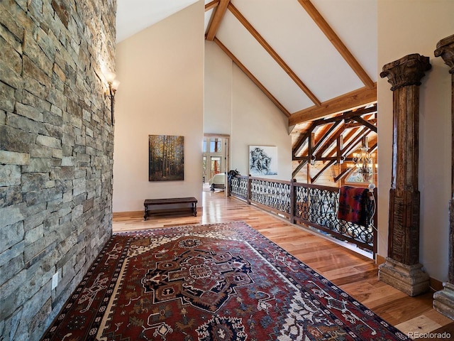 29548 Sunset Trl, Pine, CO 80470 - hall with an inviting chandelier, wood finished floors, an upstairs landing, beamed ceiling, and high vaulted ceiling