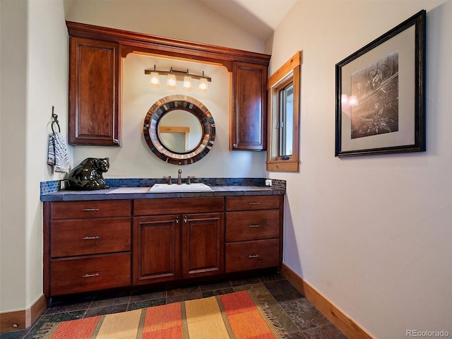 29548 Sunset Trl, Pine, CO 80470 - bathroom featuring vaulted ceiling, stone tile floors, and baseboards